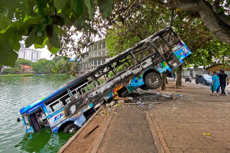 A burnt bus near Sri Lanka's former prime minister Mahinda Rajapaksa's official residence, a day after it was torched by protesters in Colombo.  AFP