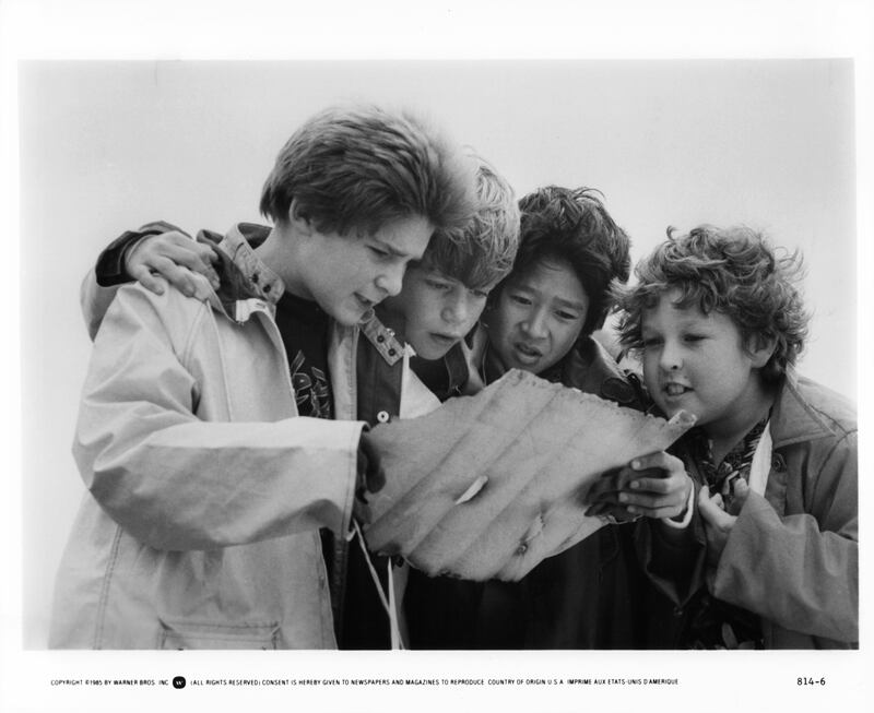 From left to right, Corey Feldman, Sean Astin, Ke Huy Quan and Jeff Cohen reading a treasure map in a scene from the film 'Goonies', 1985. (Photo by Warner Brothers/Getty Images)