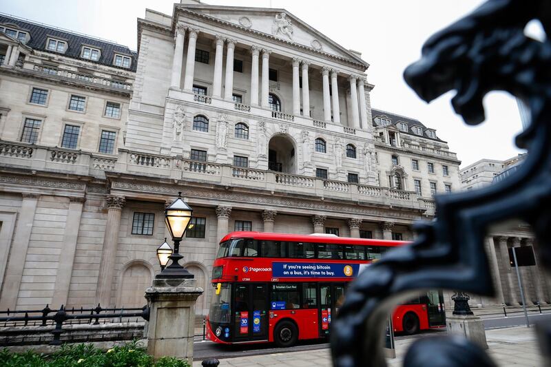 A bus passes the Bank of England (BOE) in the City of London, U.K., on Thursday, March 18, 2021. The Bank of England is likely to emphasize its high bar for tightening monetary policy, a move to tamp down speculation that a quick recovery will force policy makers to push U.K. borrowing costs higher. Photographer: Hollie Adams/Bloomberg