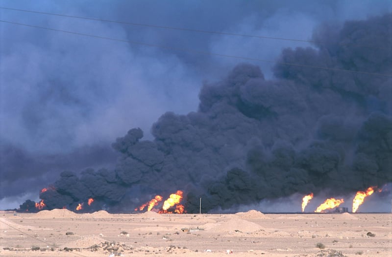 Smoke fills the air from burning oil wells that were set on fire by Iraqi forces during the Persian Gulf War. In August of 1990, Iraqi president Saddam Hussein invaded Kuwait, causing a coalition of countries to deploy troops into the region to expel Iraq from Kuwait. (Photo by Jacques Langevin/Sygma/Sygma via Getty Images)