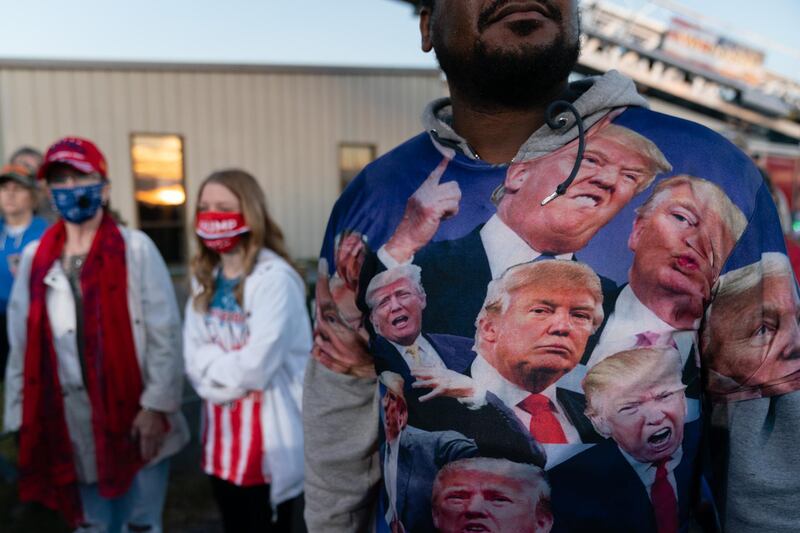 An attendee wears a shirt featuring photos of U.S. President Donald Trump during a rally with in Valdosta, Georgia, U.S. Bloomberg