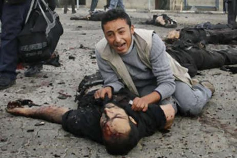 A Palestinian man reacts over the body of a member of the security forces of Hamas at the site of  an  Israeli missile strike in Gaza City.