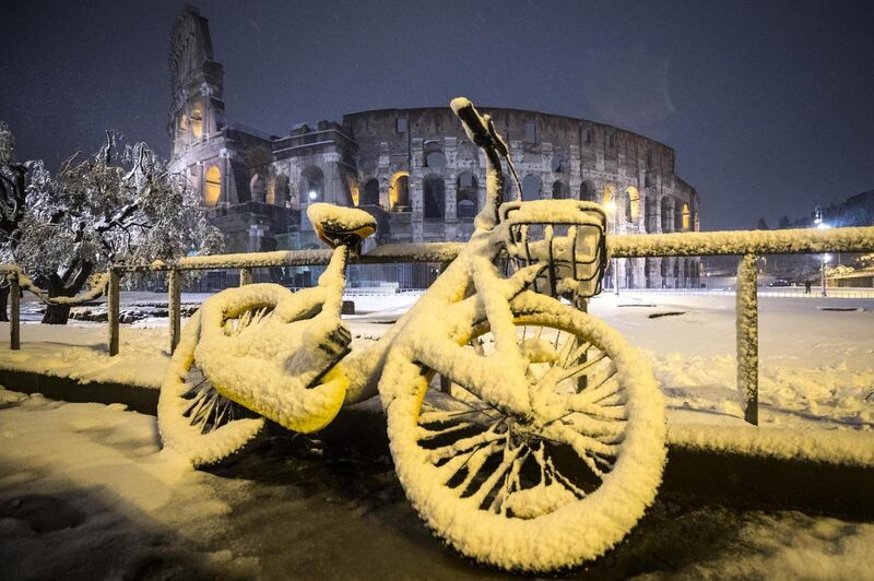 A bycicle is covered by snow in front of the Colosseum during a snowfall in Rome. Angelo Carconi / EPA