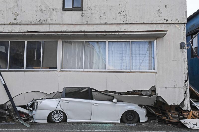 A car crushed under a collapsed building in Anamizu, Japan, after a 7.5-magnitude earthquake struck the Noto region in Ishikawa prefecture on New Year's Day. AFP