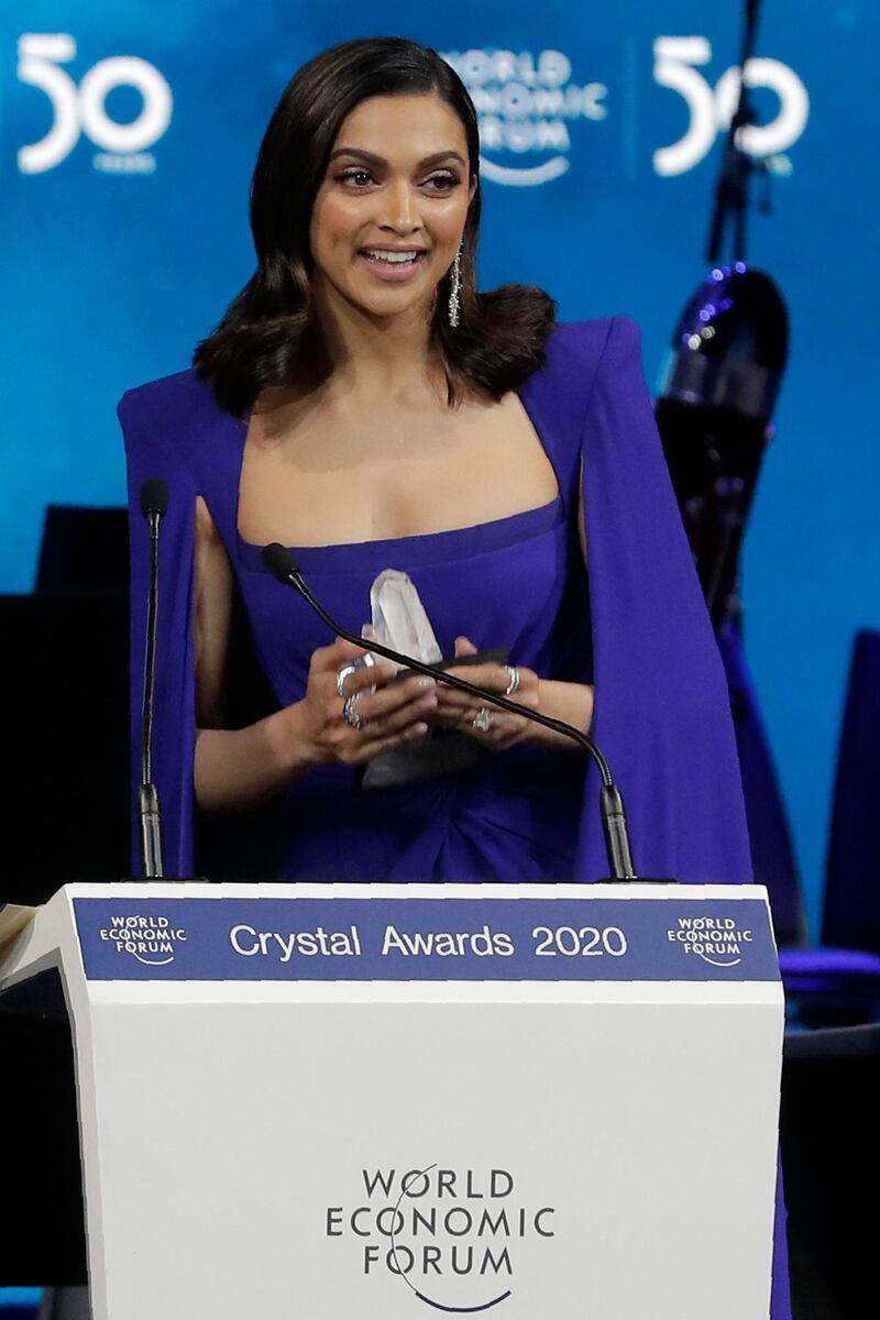 Actress Deepika Padukone, from India, smiles after receiving a Crystal Award from Hilde Schwab, Chairwoman and Co-Founder of the World Economic Forum's World Arts Forum, during the ceremony for the Crystal Awards at the annual meeting of the World Economic Forumin Davos, Switzerland, Monday, Jan. 20, 2020. The 50th annual meeting of the forum will take place in Davos from Jan. 21 until Jan. 24, 2020. (AP Photo/Markus Schreiber)