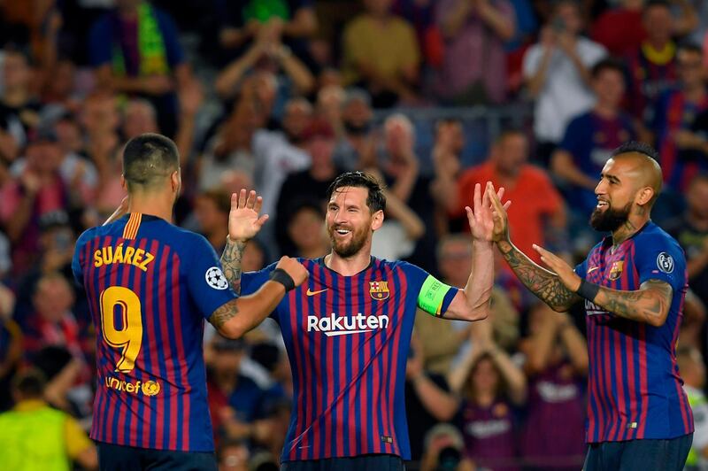 Barcelona's Argentinian forward Lionel Messi (C) celebrates with Barcelona's Uruguayan forward Luis Suarez (L) and Barcelona's Chilean midfielder Arturo Vidal after scoring his third goal during the UEFA Champions' League group B football match FC Barcelona against PSV Eindhoven at the Camp Nou stadium in Barcelona on September 18, 2018. / AFP / LLUIS GENE
