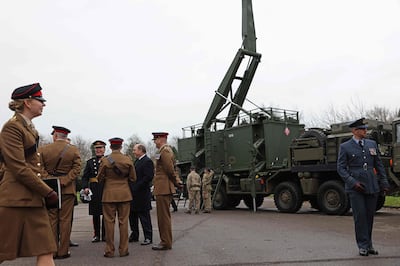Britain's Defence Secretary Ben Wallace, fifth left, speaks with officers in front of the Saab Giraffe surveillance radar, a key component of the Sky Sabre air defence system. AFP.