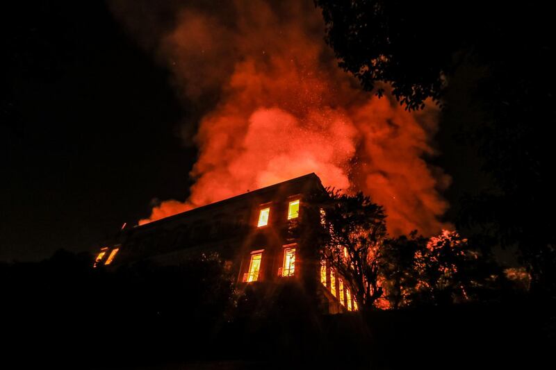 RIO DE JANEIRO, BRAZIL - SEPTEMBER 02: A fire burns at the National Museum of Brazil on September 2, 2018 in Rio de Janeiro, Brazil. The museum, which is tied to the Rio de Janeiro federal university and the Education Ministry, was founded in 1818 by King John VI of Portugal. It houses several landmark collections including Egyptian artefacts and the oldest human fossil found in Brazil.  Its collection include more than 20 million items ranging from archaeological findings to historical memorabilia. (Photo by Buda Mendes/Getty Images)