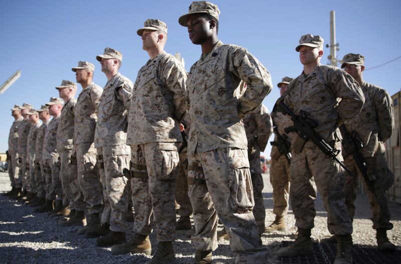 FILE - In this Jan. 15, 2018, file photo, U.S. Marines watch during the change of command ceremony at Task Force Southwest military field in Shorab military camp of Helmand province, Afghanistan. Afghan forces backed by U.S. troops in Afghanistanâ€™s turbulent Helmand Province gained ground in recent months, but the Taliban still maintains control over roughly half the province, according to the senior Marine commander who just returned from a nine-month deployment to the region. (AP Photo/Massoud Hossaini, File)