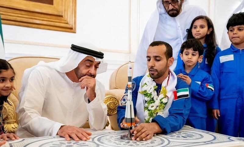 rABU DHABI, UNITED ARAB EMIRATES - October 12, 2019: HH Sheikh Mohamed bin Zayed Al Nahyan, Crown Prince of Abu Dhabi and Deputy Supreme Commander of the UAE Armed Forces (2nd L) looks at a model of the Soyuz MS-15 space ship which launched Hazza Ali Al Mansoori, the first UAE Astronaut (3rd L) to the International Space Station, during a homecoming reception at the Presidential Airport.

( Hamad Al Kaabi / Ministry of Presidential Affairs )​
---