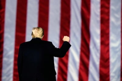 FILE - In this Monday, Jan. 4, 2021, file photo, President Donald Trump gestures at a campaign rally in support of Senate candidates Sen. Kelly Loeffler, R-Ga., and David Perdue in Dalton, Ga. Trump will travel to Texas on Tuesday, Jan. 12, 2021, to trumpet one of the pillars of his presidency: his campaign against illegal immigration. It's part of an effort by aides to try to salvage a Trump legacy that will forever be stained by the siege he incited on the U.S. Capitol the week before. (AP Photo/Brynn Anderson, File)
