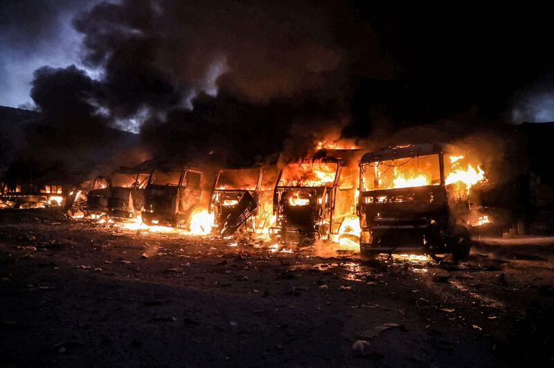 A view of trucks and freight vehicles on fire in the aftermath of air strikes at a depot near the Bab al-Hawa border crossing between Syria and Turkey in Syria's rebel-held northwestern Idlib province.  AFP