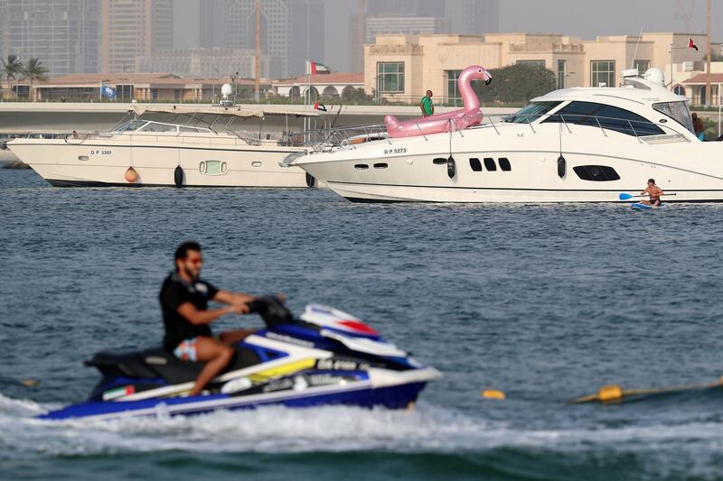 Dubai, United Arab Emirates - Reporter: N/A. Sport. People compete in the moto surf section of the Dubai Watersports Summer Week. Thursday, June 25th, 2020. Dubai. Chris Whiteoak / The National