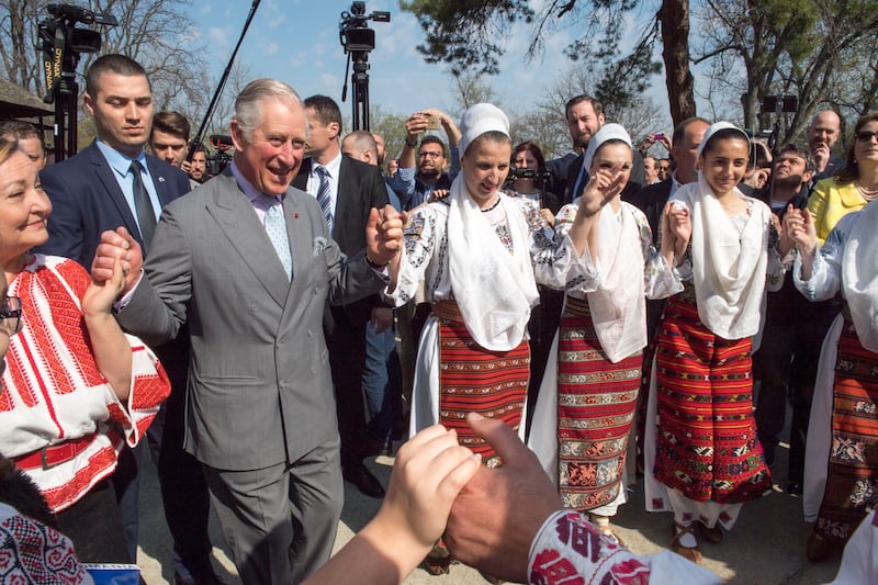 Prince Charles dances with Romanian dancers at a village museum in Bucharest, Romania, in 2017.