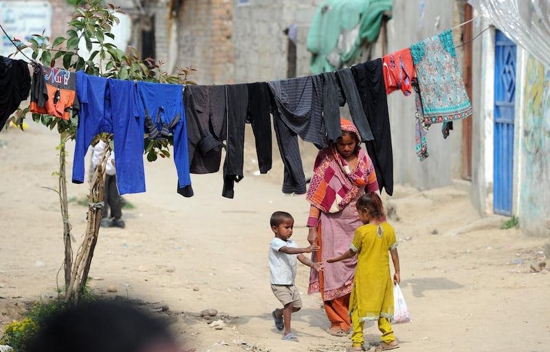 A Pakistani Christian woman walking with her children in the slums of Islamabad. Aamir Qureshi / AFP
