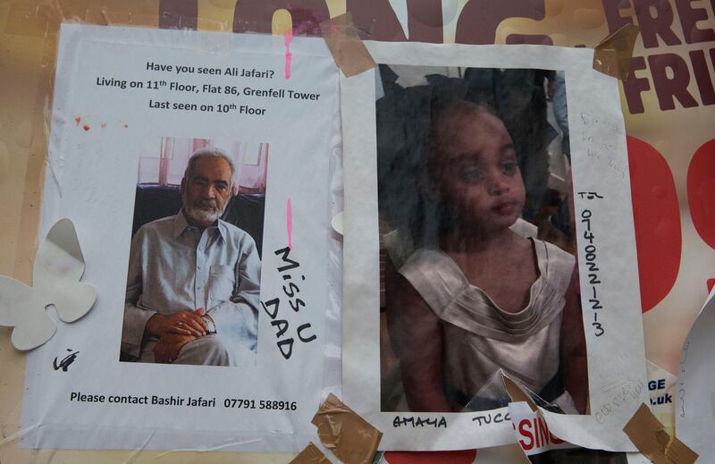 Faded pictures of those missing near the scene of the Grenfell Tower fire in London, a month after the disaster.