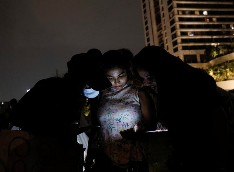 Residents of Gota-Go Village in Colombo use their phones to organise their protest against President Gotabaya Rajapaksa's management of the economy. Reuters