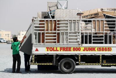 Dubai, United Arab Emirates - Reporter: Nada El Sawy: Sadek (Blue hat) puts a table on the lorry. Junk-removal services like Take My Junk are a good way to get rid of your unwanted items. The most cost-effective way to get rid of your unwanted items. Tuesday, March 17th, 2020. Mirdif, Dubai. Chris Whiteoak / The National