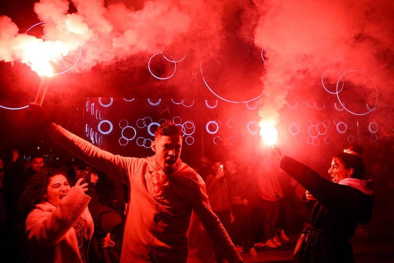 Supporter hold smoke flares as they celebrate France's victory over Morocco in the Qatar 2022 World Cup semi-final, in Marseille on December 14, 2022.  (Photo by Nicolas TUCAT  /  AFP)