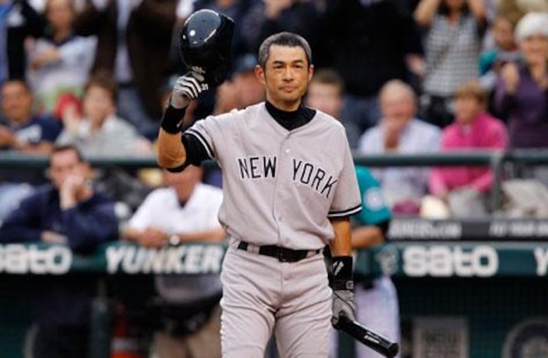 Ichiro Suzuki doffs his cap to the Seattle crowd after signing for the New York Yankees