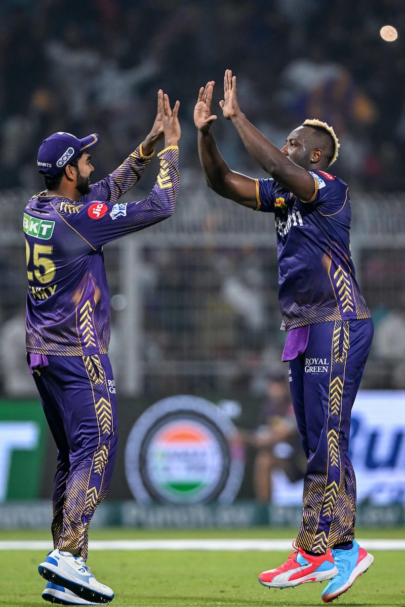 Kolkata Knight Riders' Andre Russell, right, celebrates with his teammate Venkatesh Iyer after taking the wicket of Sunrisers Hyderabad's Abhishek Sharma. AFP
