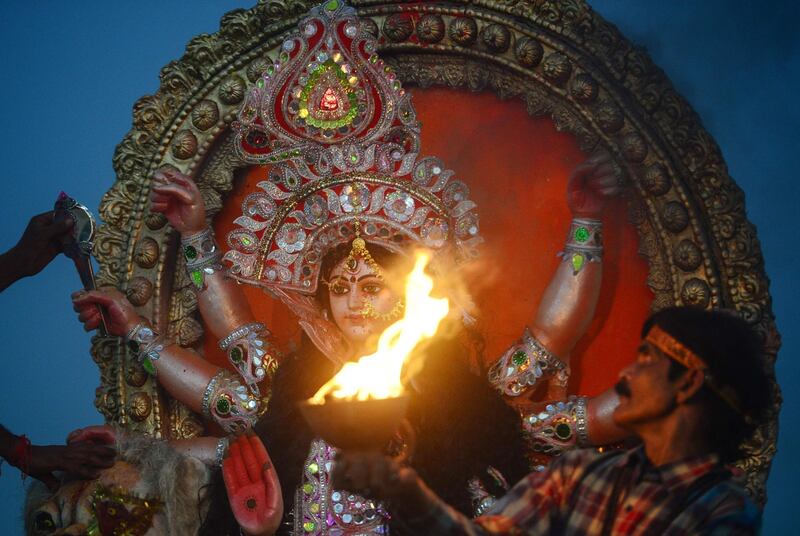 Indian Hindu devotees carry an idol of the goddess Durga to be immersed in a temporary pond near Sangam as part of the Durga Puja festival in Allahabad. AFP