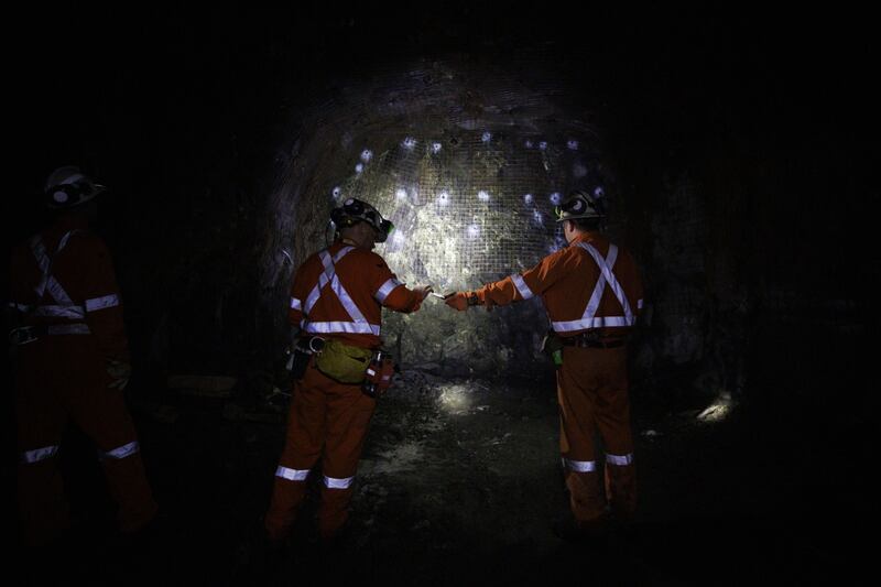 Workers in front of a wall containing minerals and metals in the Vale Copper Cliff mine in Sudbury, Canada. Bloomberg