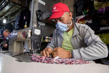 A semester works upon reopening shops in downtown Amman, Jordan, 30 April 2020. EPA  