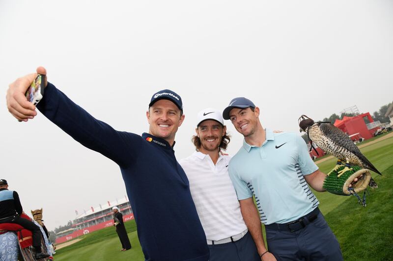Justin Rose, left, takes a selfie with Tommy Fleetwood and Rory McIlroy ahead of the Abu Dhabi HSBC Championship. Ross Kinnaird / Getty Images