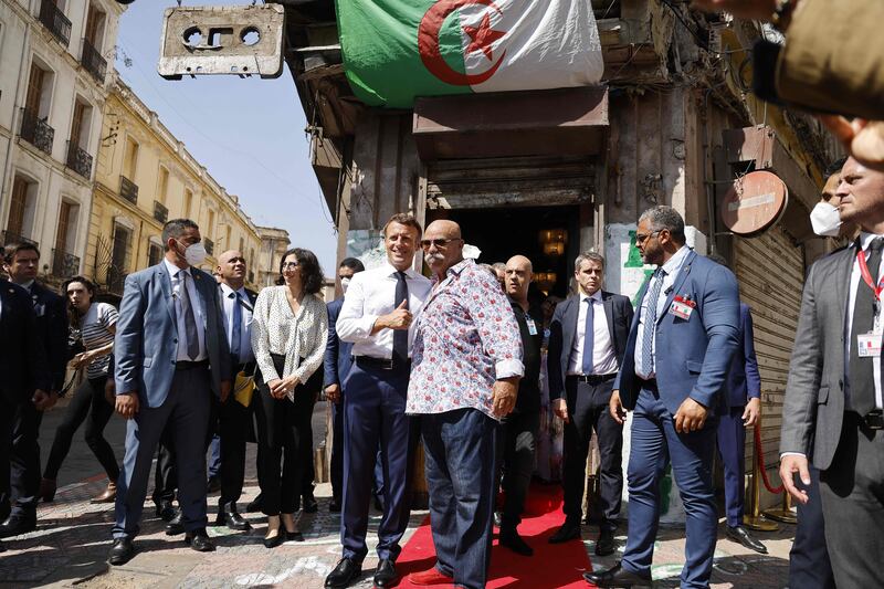 France's President Emmanuel Macron visits the Disco Maghreb music store in Oran, a home to Algeria's rai music, to meet its owner Boualem Benhaoua. AFP