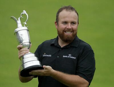 FILE - In this Sunday, July 21, 2019 file photo Ireland's Shane Lowry holds the Claret Jug trophy on the 18th green as he poses for the crowd and media after winning the British Open Golf Championships at Royal Portrush in Northern Ireland. The organizers of the British Open announced Monday April 6, 2020, that they have decided to cancel the event in 2020 due to the current Covid-19 pandemic and that the Championship will next be played at Royal St George's in 2021. (AP Photo/Matt Dunham)