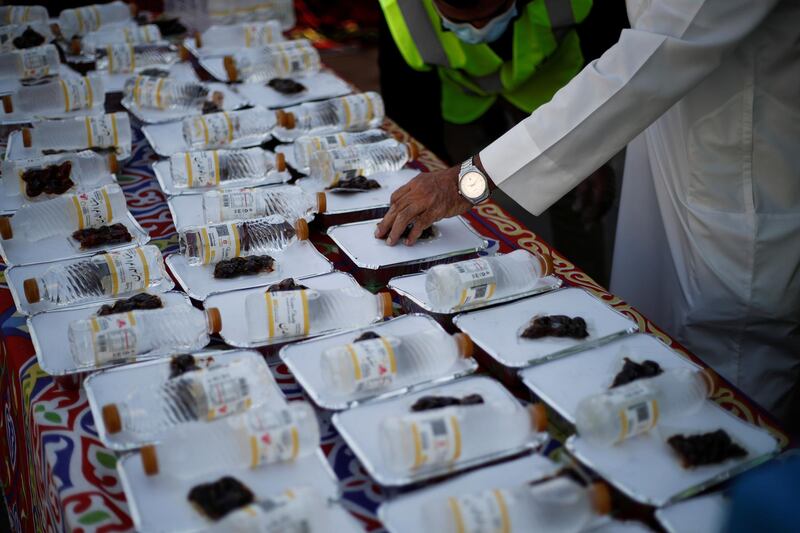 A volunteer from Adliya Charity arranges meals for distribution during Ramadan, in Manama, Bahrain. Reuters