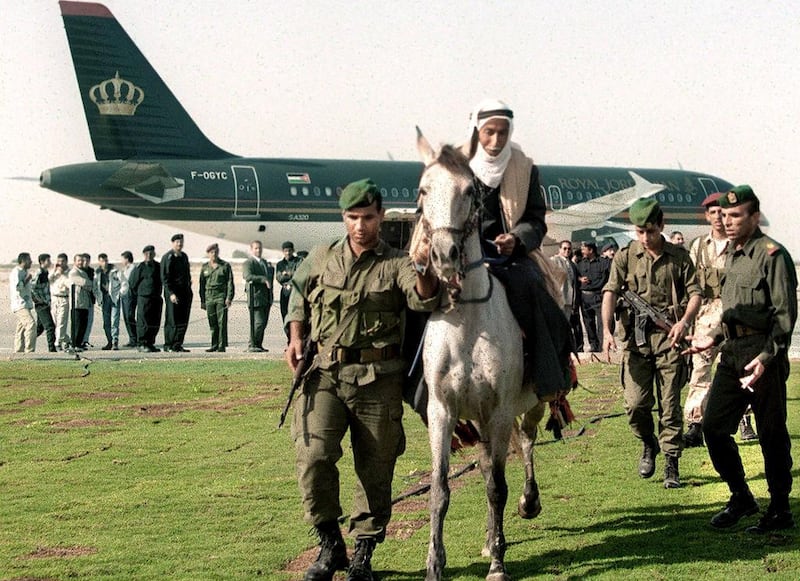 November 24, 1998: A Palestinian policeman leads a horse rider away from a Jordanian plane which landed on the Gaza international airport before its opening day. AFP Photo