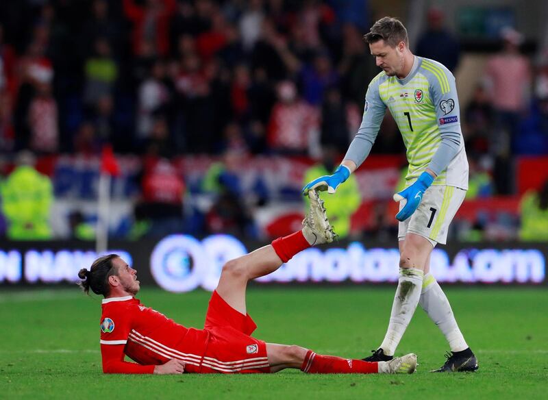 Soccer Football - Euro 2020 Qualifier - Group E - Wales v Croatia - Cardiff City Stadium, Cardiff, Britain - October 13, 2019 Wales' Gareth Bale is helped by Wayne Hennessey during the match Action Images via Reuters/Andrew Couldridge