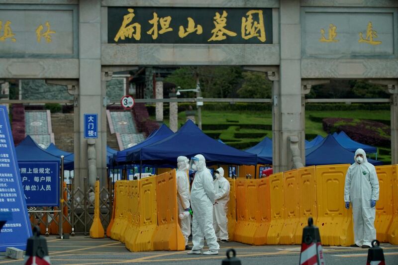 People wearing protective suits in the Chinese city of Wuhan, the centre of the country's Covid-19 outbreak, in April 2000. Reuters