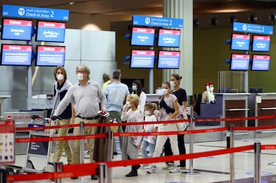 A family walks at Dubai International Airport, as Emirates airline resumed limited outbound passenger flights amid outbreak of the coronavirus disease (COVID-19) in Dubai, UAE April 27, 2020. REUTERS/Ahmed Jadallah