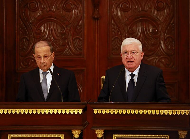Iraqi President Fuad Masum, right, and Lebanese President Michel Aoun, left, hold a press conference in Salam Palace in Baghdad, Iraq, Tuesday, Feb. 20, 2018. (AP Photo/Hadi Mizban)