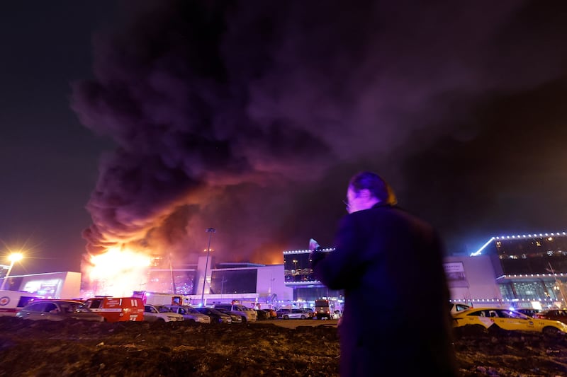 Smoke rises above the venue following the shooting. Some witnesses reported explosions. Reuters