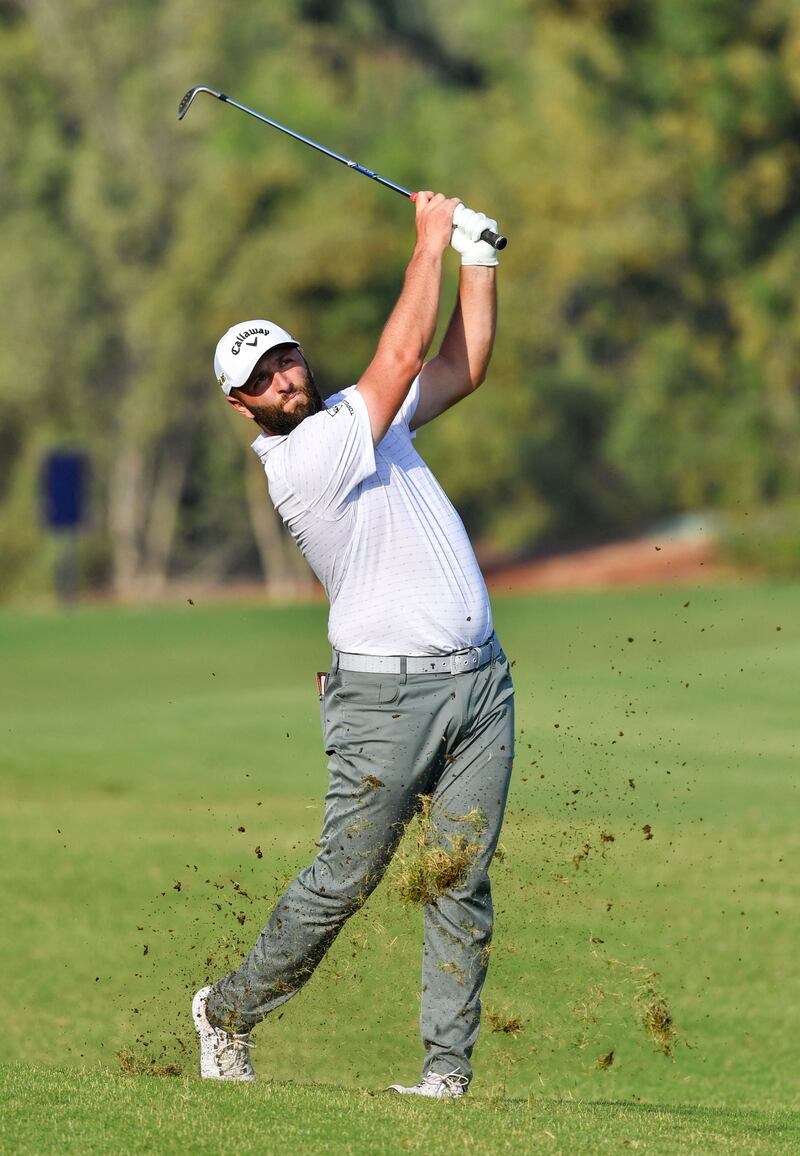 John Rahm shoots for the 14th green. AFP