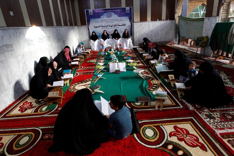 Women read the Quran at Al Qasim Mosque during the blessed month of Ramadan in the central Iraqi city of Hilla. Reuters