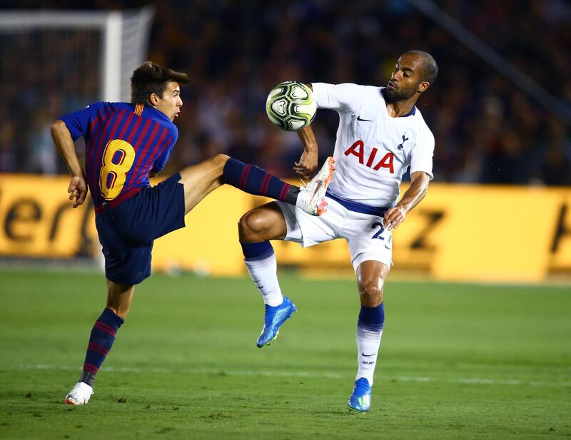 Barcelona player Ricard Puig battles for the ball against Tottenham Hotspur midfielder Lucas Moura. Reuters