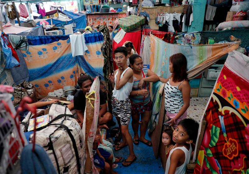 Filipinos take shelter inside a gymnasium in Paranaque. EPA