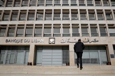 FILE - This Jan. 22, 2019, file photo, a man heads to the Lebanese central bank in Beirut, Lebanon. Lebanon's central bank has issued guarantees to secure U.S. dollars for local banks at the fixed official rate that would cover imports of fuel, wheat and medicine. The central bank's move on Tuesday, Oct. 1, 2019 aims to ease the demand for dollars at a time when many Lebanese are rushing to exchange shops to convert their local currency into dollars. (AP Photo/Hussein Malla, File)