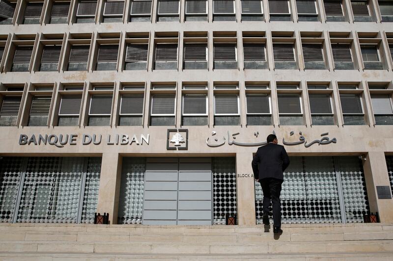 FILE - This Jan. 22, 2019, file photo, a man heads to the Lebanese central bank in Beirut, Lebanon. Lebanon's central bank has issued guarantees to secure U.S. dollars for local banks at the fixed official rate that would cover imports of fuel, wheat and medicine. The central bank's move on Tuesday, Oct. 1, 2019 aims to ease the demand for dollars at a time when many Lebanese are rushing to exchange shops to convert their local currency into dollars. (AP Photo/Hussein Malla, File)