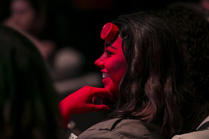 A girl dressed as helot smiles during an event.