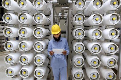 A worker inspects operations in Riyadh's Ras Al Khair desalination plant, the largest in the world. It is in desalination that the Mena benefits of AI could be felt most. Reuters