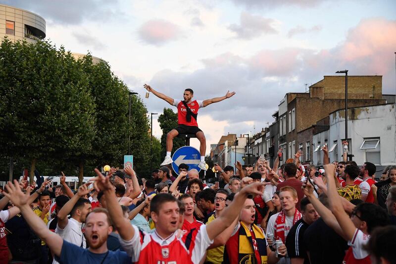 Arsenal fans celebrate outside the Emirates stadium. AFP