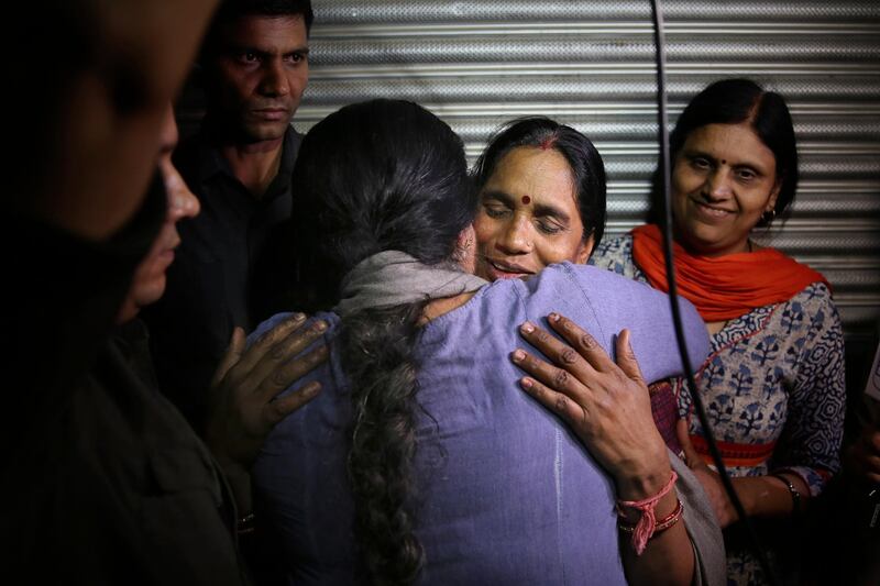 Asha Devi, mother of the victim of the fatal 2012 gang rape and murder on a moving bus in New Delhi is embraced by an unidentified woman after the rapists of her daughter were hanged. AP Photo