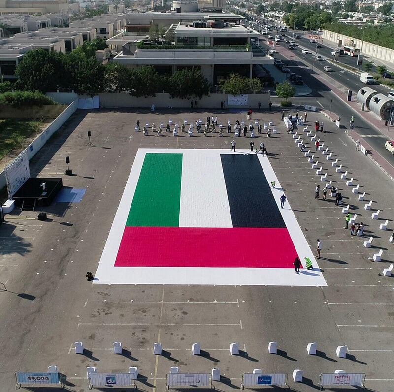 DUBAI, 28th April, 2021 (WAM) -- An outstanding piece of UAE flag made with mosaic, and measuring 498.33 m², has been added to the Guinness World Records under "Nefsy’s" initiative during the 49th UAE National Day last year. Wam
