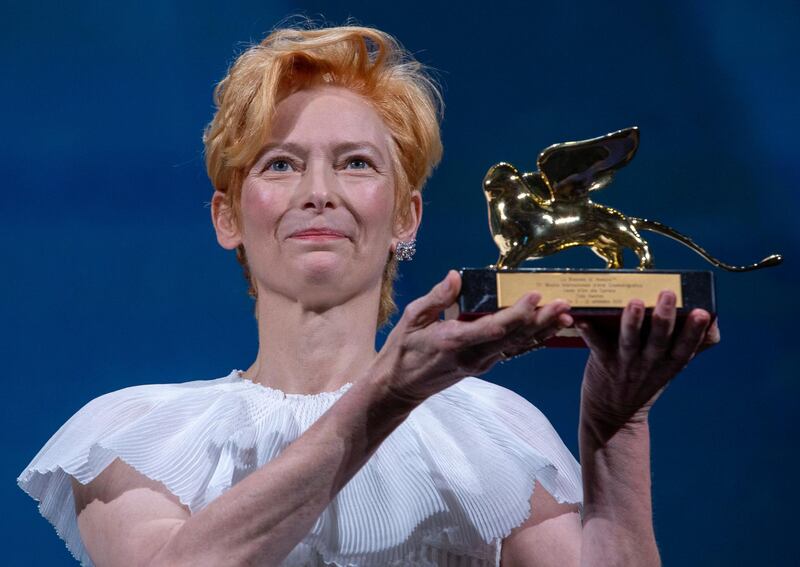 Tilda Swinton holds her Golden Lion For Lifetime Achievement award. AP